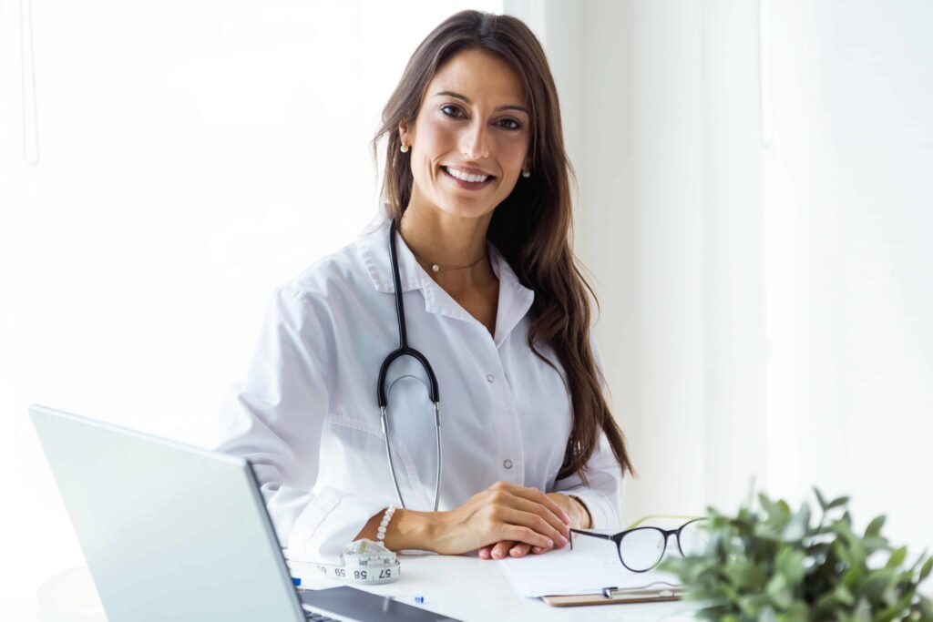 Beautiful young female doctor looking at camera in the office.-Subhag-IUI